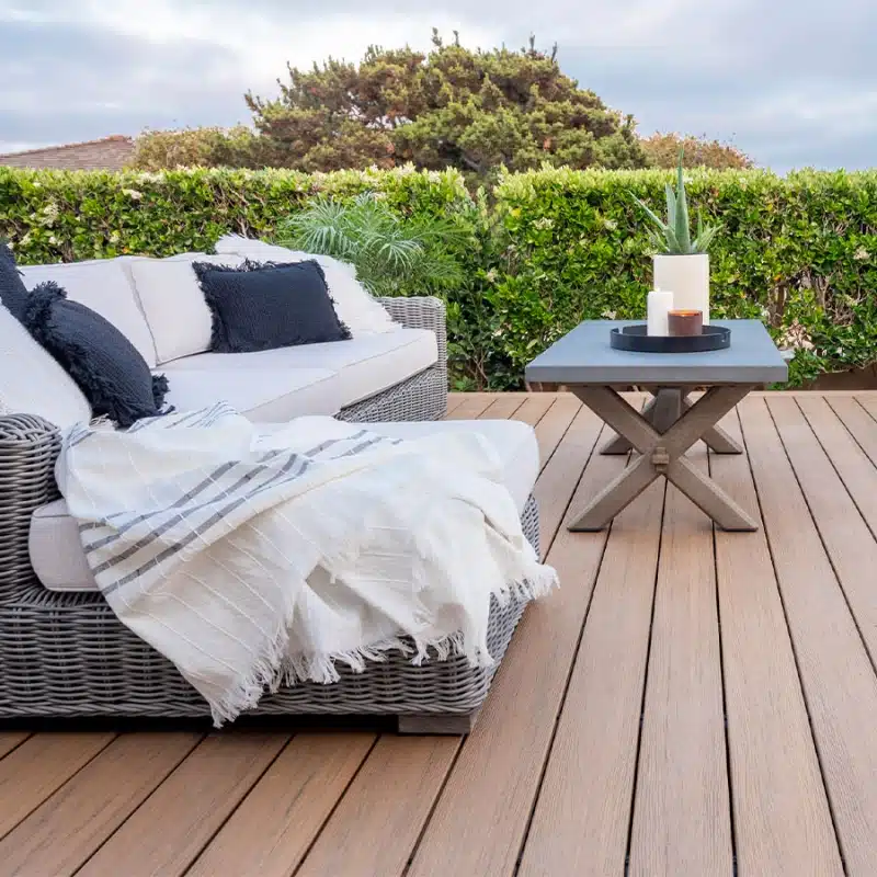 antique-leather-reserve-composite-deck-with-outdoor-living-couch-surrounded-by-grass-and-cloudy-sky-on-the-background-in-south-east-pa